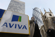 Pedestrians walk past Aviva's global head office in London. The British company uses a 